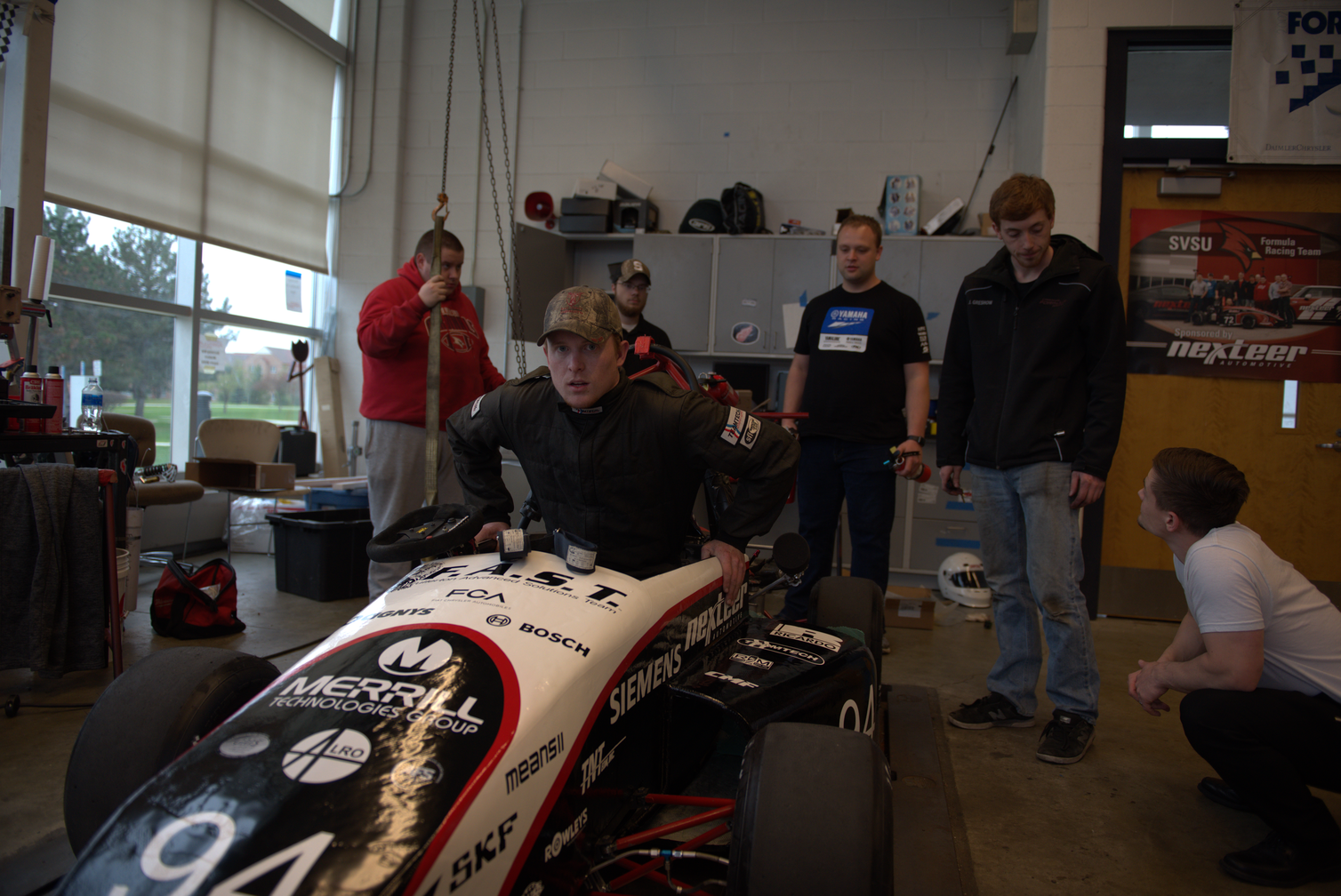 Students around race car on stand